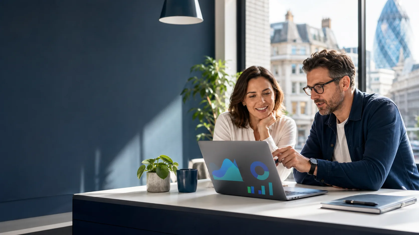 A business owner and SEO consultant reviewing website performance in a London studio